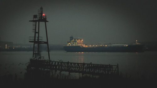 Illuminated tower in city at night