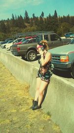 Side view of young woman walking on road