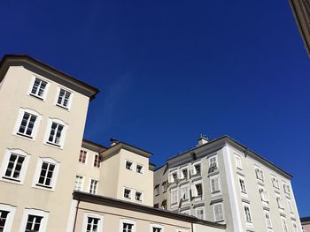 Low angle view of residential building against blue sky