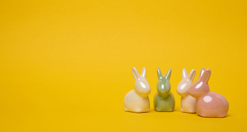 High angle view of chess pieces against yellow background