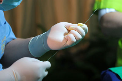 Close-up of man holding hands
