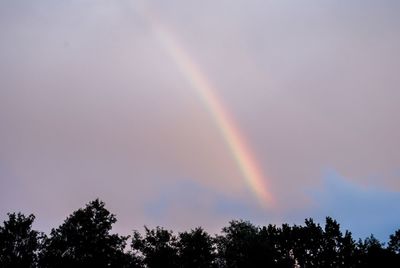 Low angle view of rainbow against sky at sunset