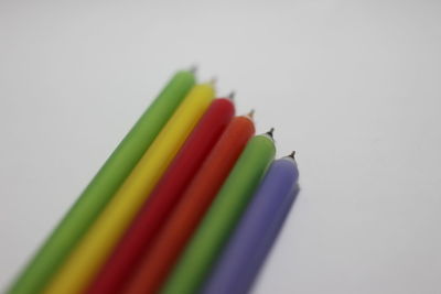 Close-up of colored pencils against white background