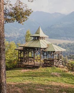 Built structure on field against mountains