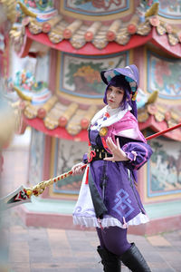 Portrait of young woman walking on street