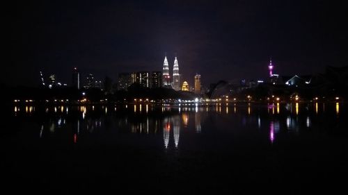 Illuminated city against sky at night