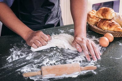 Midsection of man preparing food on table