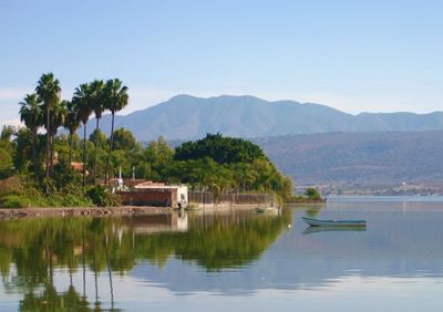 Scenic view of lake and mountains against sky