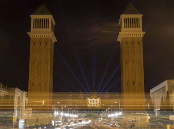 Low angle view of illuminated buildings in city at night
