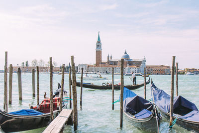 Man in gondola on grand canal against church of san giorgio maggiore