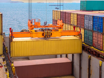 Containers are discharging from vessel by port crane at port of thailand,