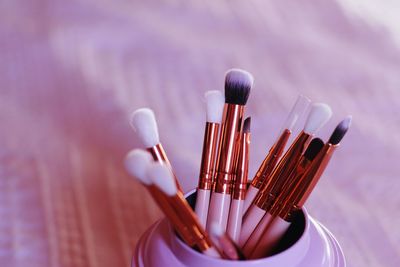 Close-up of make-up brushes in container