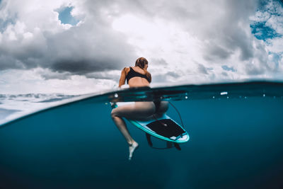 Low section of woman swimming in sea