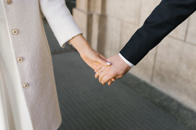 Bride and groom are holding hands. st. valentine's day in a couple person