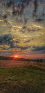 Scenic view of field against sky during sunset