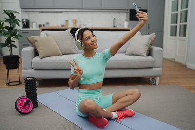 Portrait of young woman exercising at home