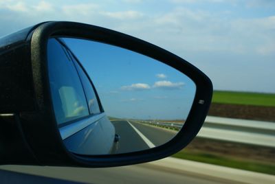 Reflection of road on side-view mirror