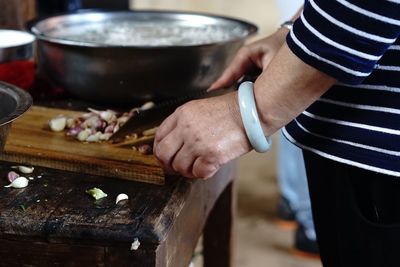 Midsection of woman preparing food in kitchen