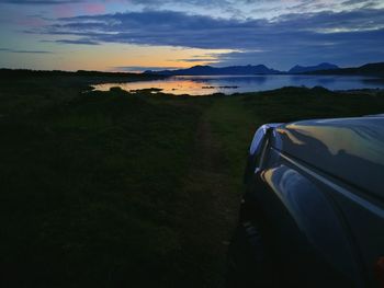 Scenic view of river against sky during sunset