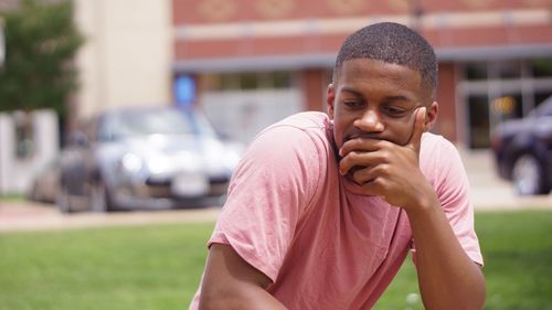 Close-up of thoughtful man on field