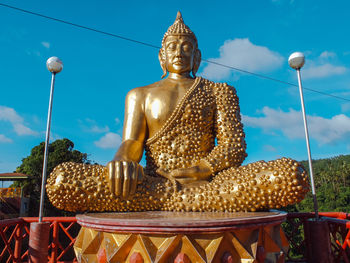 Statue of buddha against blue sky