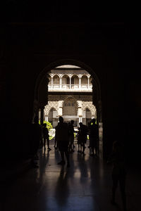 Group of silhouette people in front of historical building