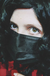 Close-up portrait of woman covering face