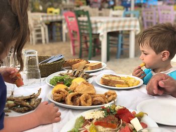 Family having food at table in restaurant