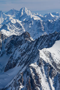 Scenic view of snowcapped mountain against blue sky