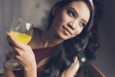 Close-up of young woman holding wineglass