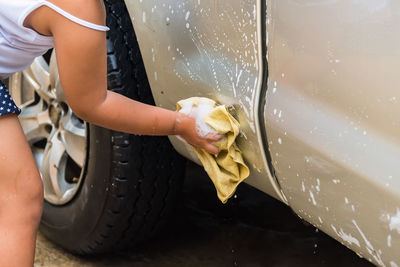 Midsection of woman working in water