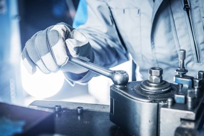 Midsection of manual worker working in factory