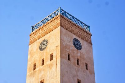 Low angle view of bell tower against blue sky