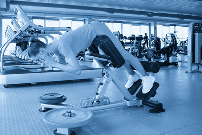 Low section of man exercising in gym