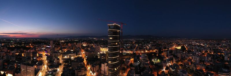 High angle view of city lit up at night