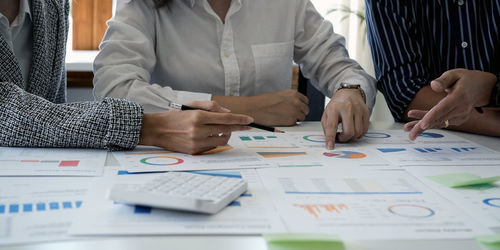 Midsection of business colleagues working at office