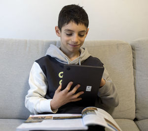 Portrait of young man using laptop at home