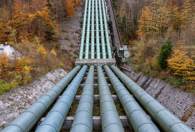 Water pipeline of hydroelectric power plant in forest during autumn