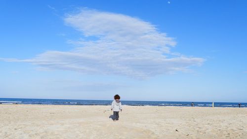 Full length of man on beach against sky