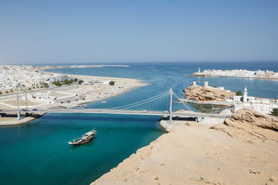 Sur cityscape with al aygaz suspension bridge. travel destination on coast of the gulf of oman.