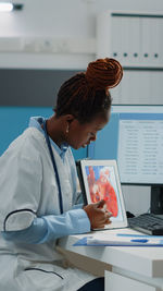 Female doctor using digital tablet at clinic