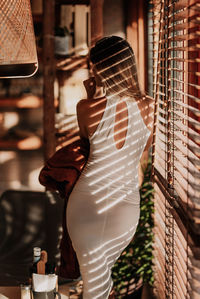 Rear view of woman standing in bakery 