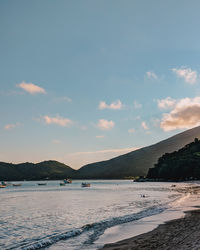 Scenic view of beach against sky during sunset