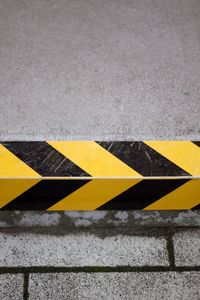 High angle view of arrow sign on road