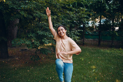 Portrait of young woman exercising at park