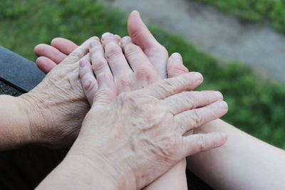 Female hands, young female hands hold the hand of an elderly woman