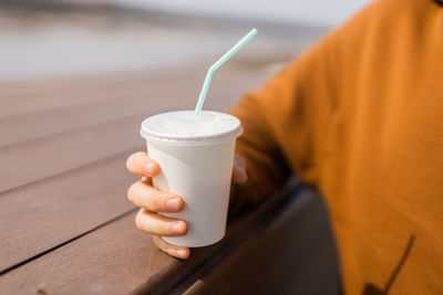 Midsection of man holding coffee