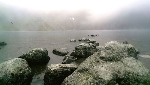 View of calm sea against rocks