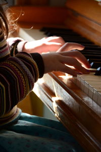 Close-up of hands playing piano