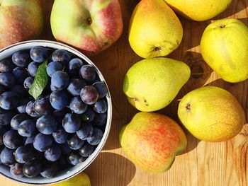 High angle view of pears and plums   on table